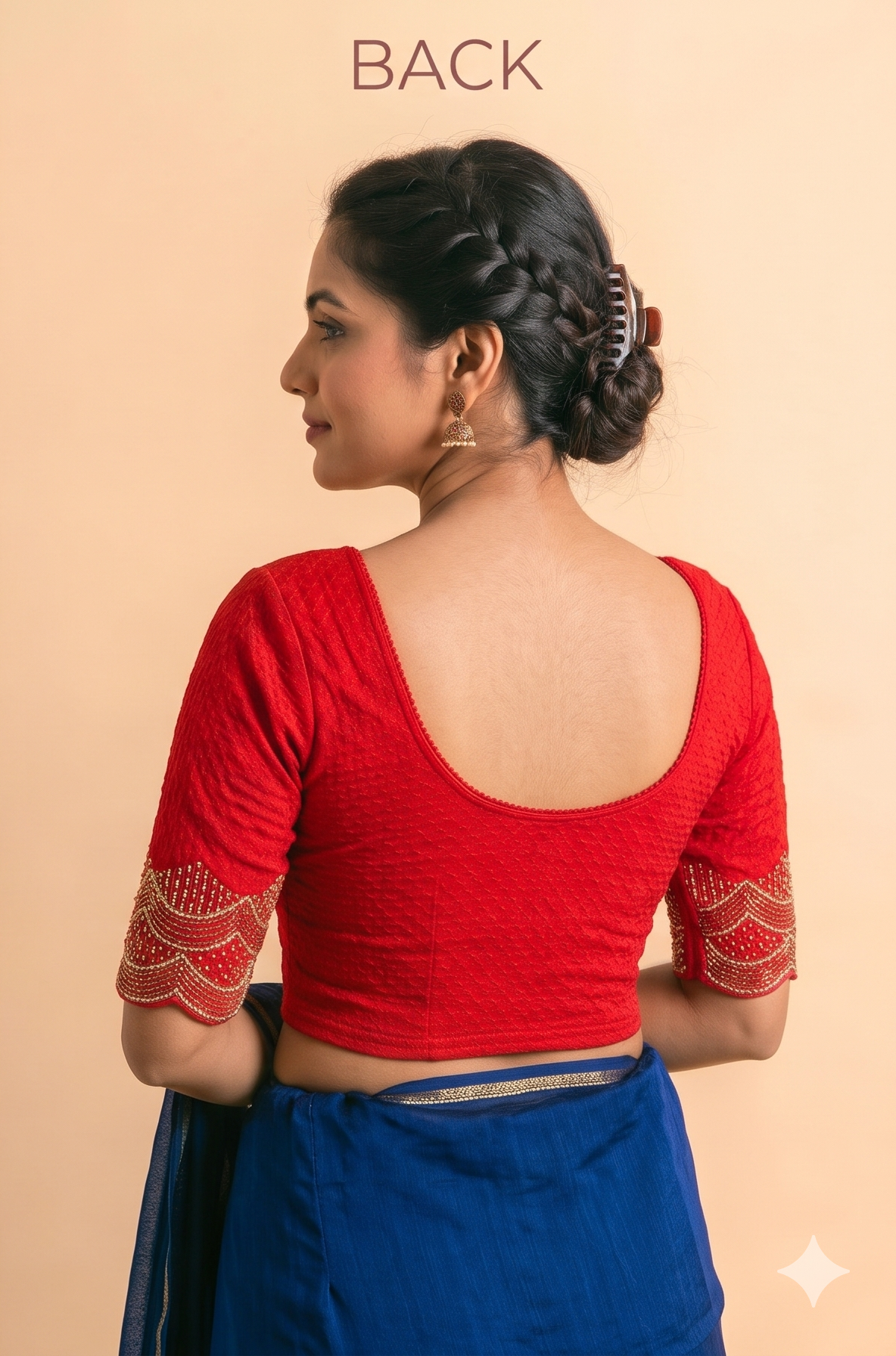 Back of a red stretchable blouse with a deep scoop back and gold pipe-work embroidered sleeve cuffs