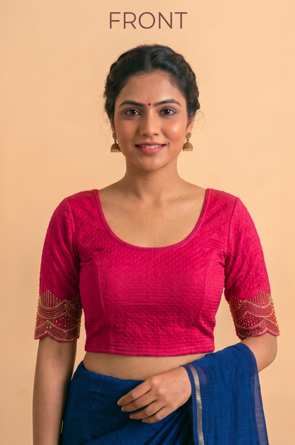 Pink stretch blouse with a scoop neckline and short sleeves with gold-patterned cuffs