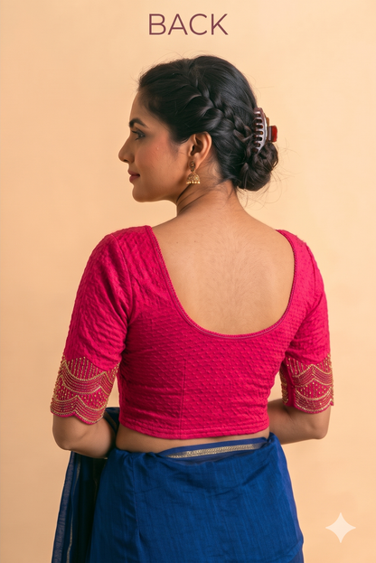 Pink stretch blouse with a low scoop back and short sleeves with gold-patterned cuffs