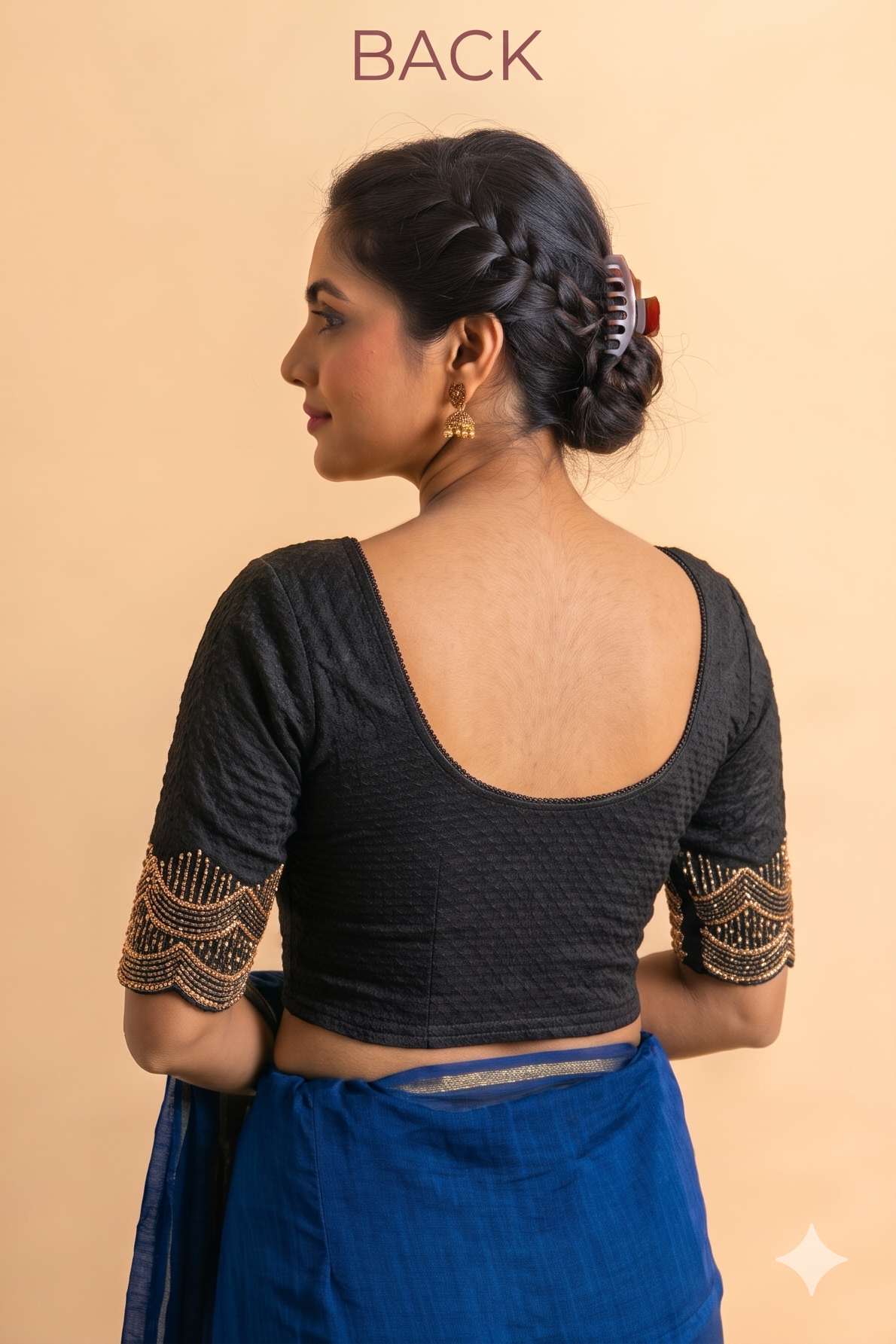 Back of black stretchable blouse with a deep scoop back and gold pipe-work sleeve details