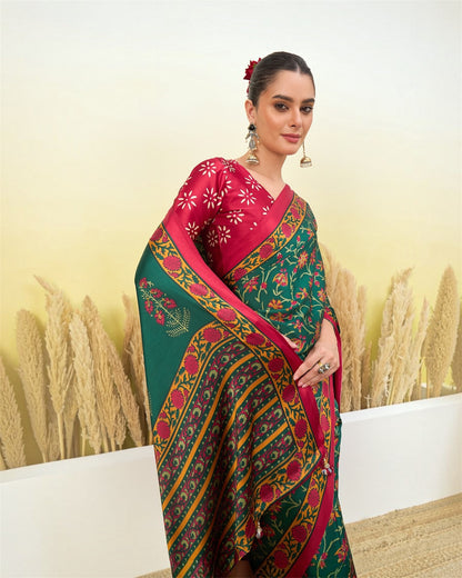 Green printed saree with maroon short-sleeve blouse and ornate gold border