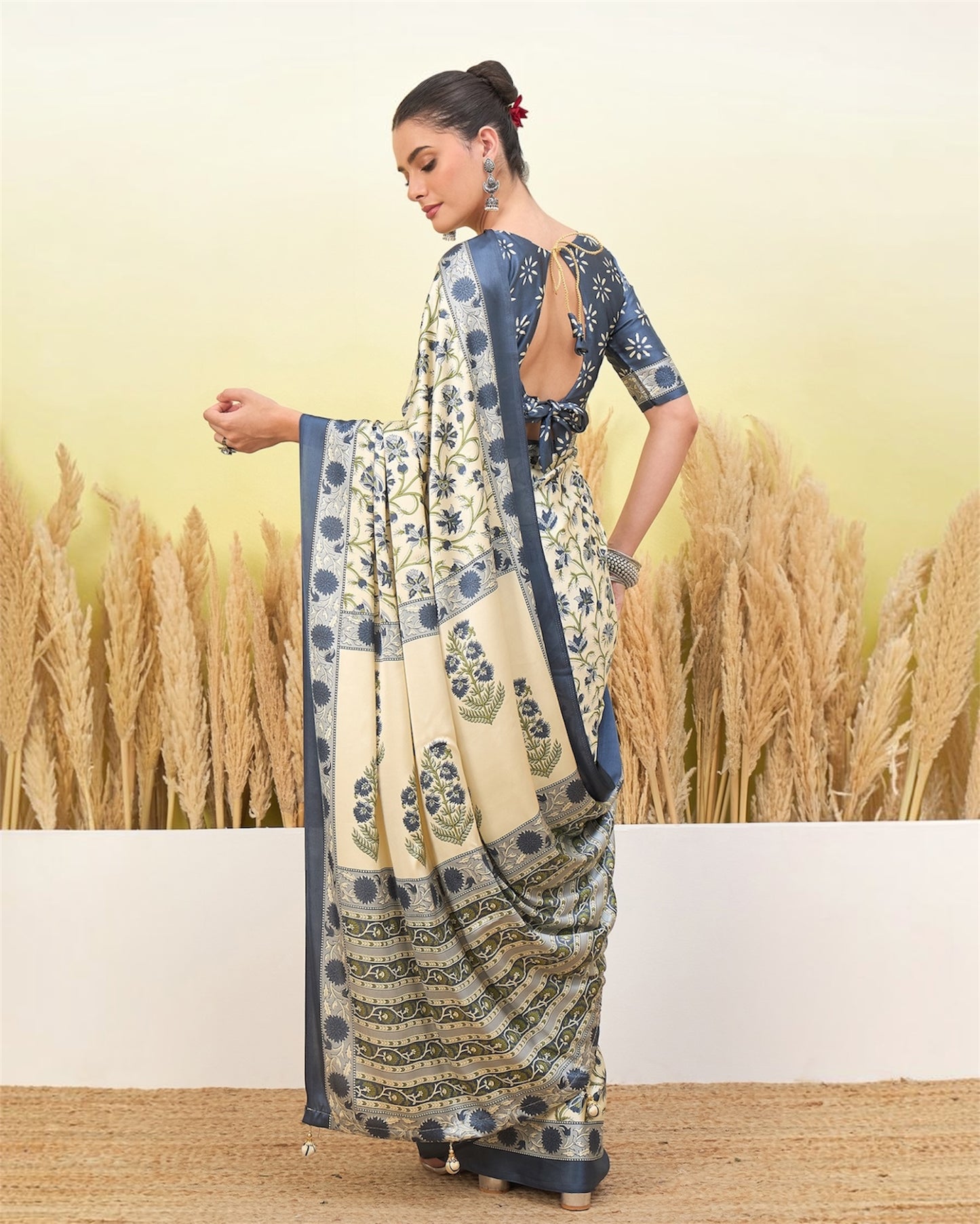 Ivory and blue crepe silk easy saree with floral motifs, draped with border