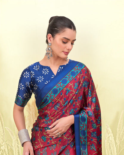 Blue blouse-style top and red printed saree with floral motifs and diagonal border