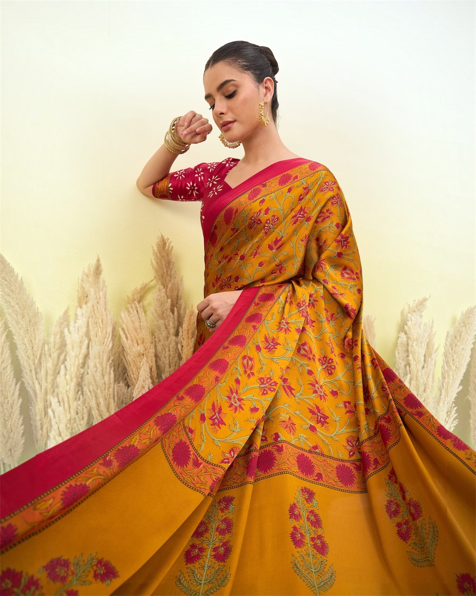 Mustard and pink crepe silk saree with wide border floral motifs, flowing drape