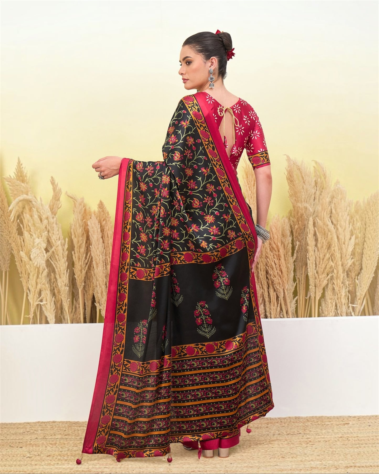 Black crepe silk ready-to-wear saree with pink blouse and floral border, back view