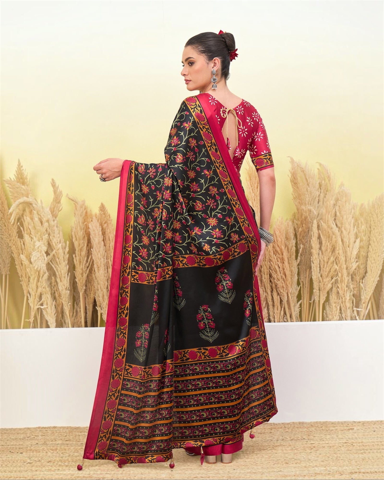 Black crepe silk ready-to-wear saree with pink blouse and floral border, back view