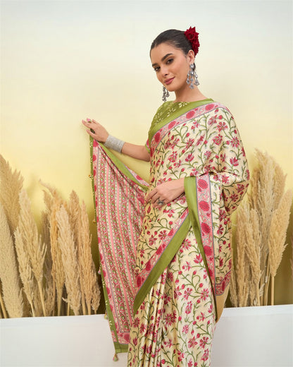 Ivory crepe silk saree with green border and red floral print, side drape view.