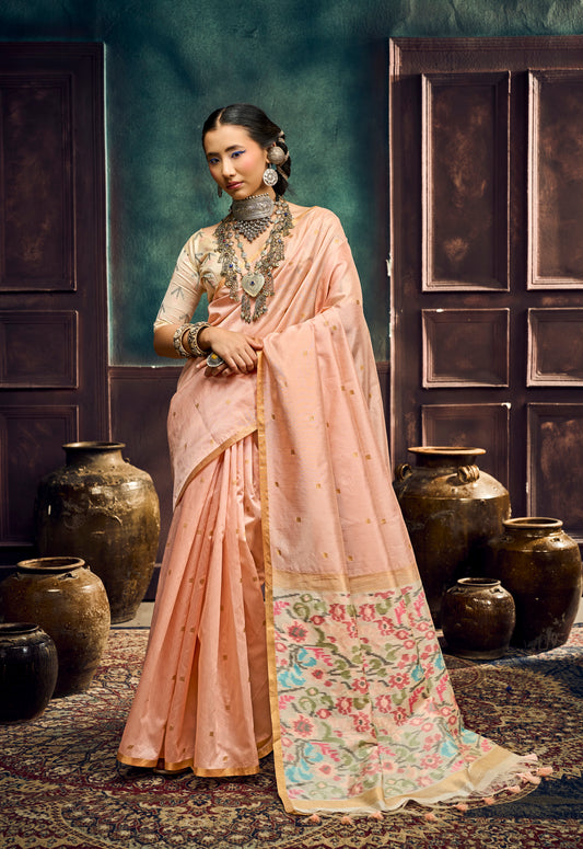 Peach saree worn with matching blouse; floral border pallu with gold dot detailing