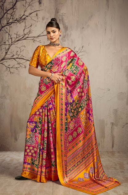 Model wearing a yellow saree with multicolor floral panels and a gold border