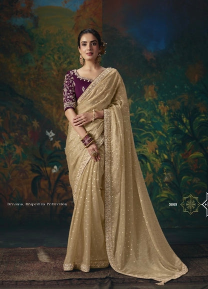 Gold tissue silk ready-to-wear saree with dotted fabric and ornate border, paired with a purple blouse