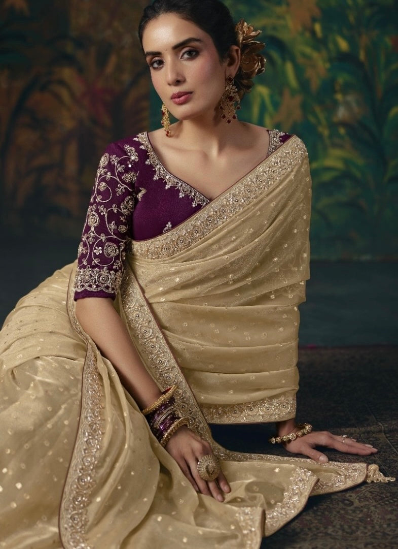 Gold tissue silk saree with embellished border and dotted fabric, shown with a purple embroidered blouse