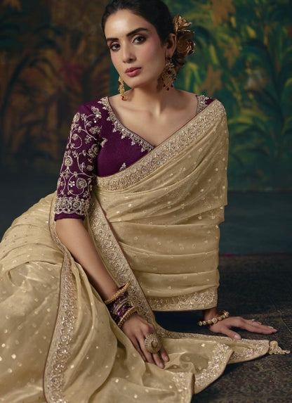 Gold tissue silk saree with embellished border and dotted fabric, shown with a purple embroidered blouse