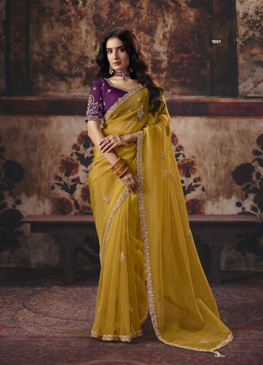 Mustard-gold silk saree with purple blouse, embellished border and gold trim