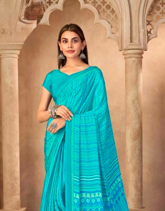 Turquoise crepe silk saree with geometric border, draped pallu over shoulder, matching blouse