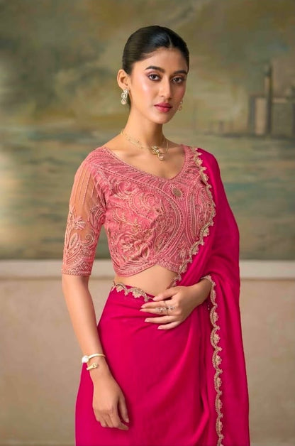 Fuchsia pink saree with embroidered V-neck blouse and draped pallu at shoulder