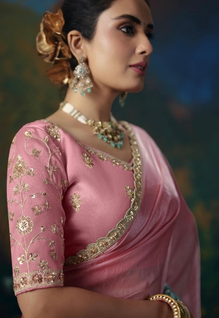 Pink embroidered blouse and tissue silk saree with ornate gold edging