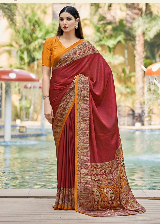 Brick red crepe silk saree with ornate gold patterned border and pallu