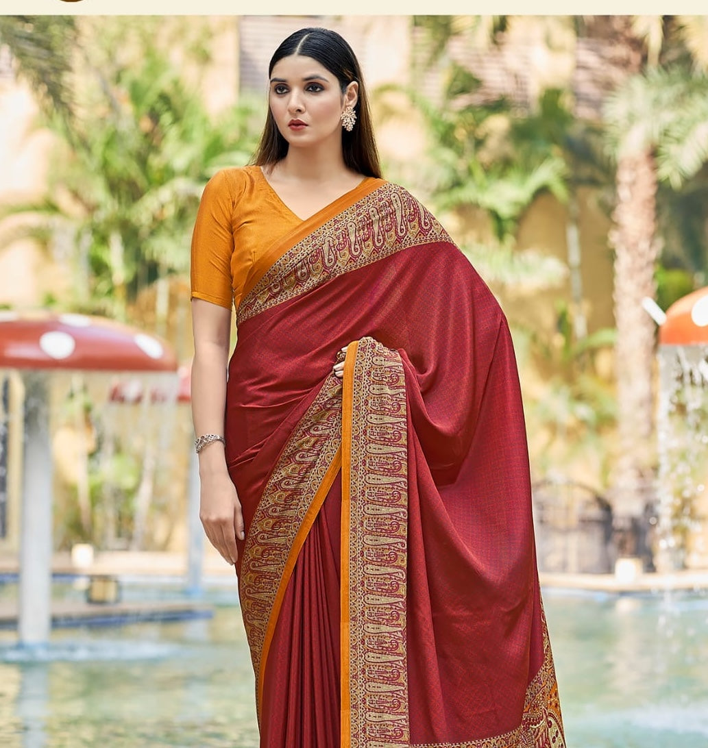 Brick red crepe silk saree with gold patterned border and draped pallu