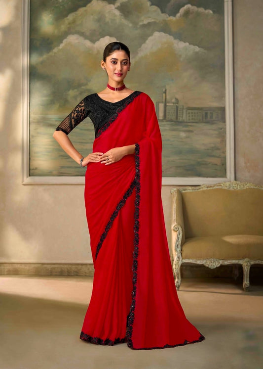 Red ready-to-wear saree with black lace border, draped over shoulder and waist.