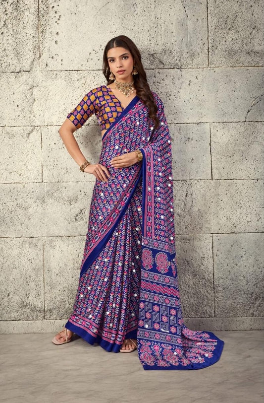 Indigo blue patterned saree with pink motifs, draped with border and pallu
