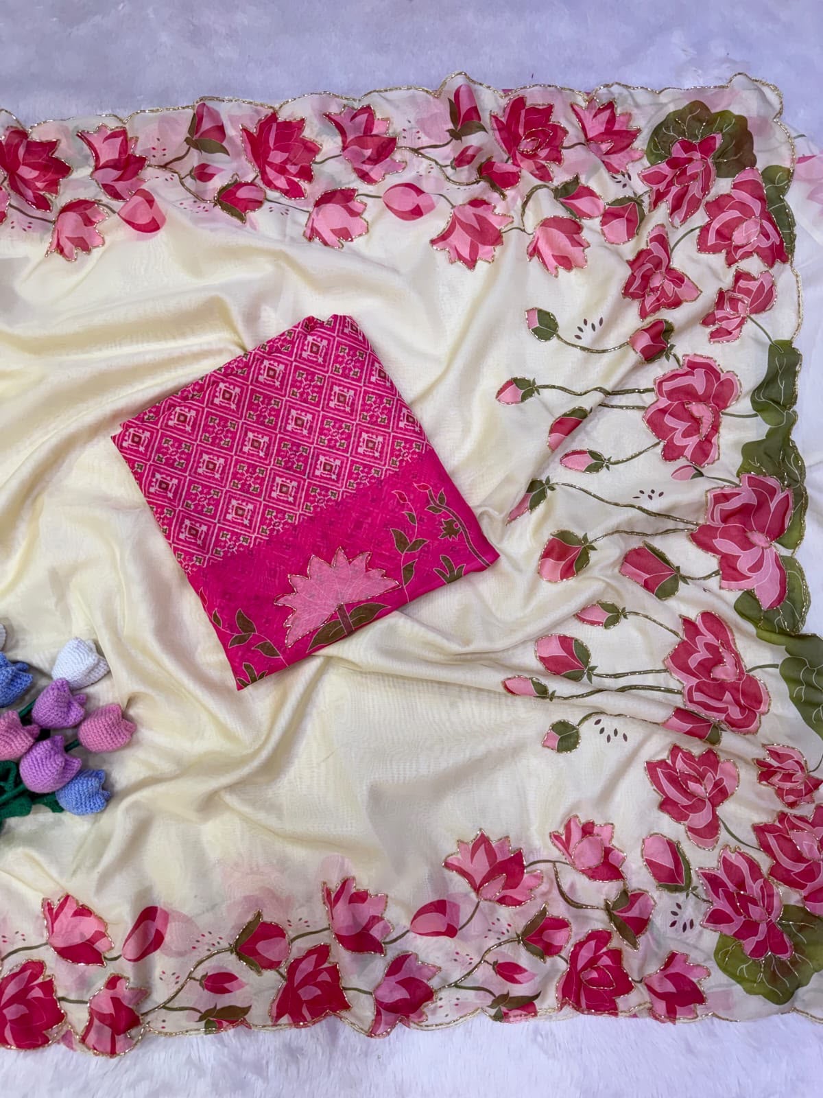 Off-white organza-like fabric swatch with pink floral border and patterned weave