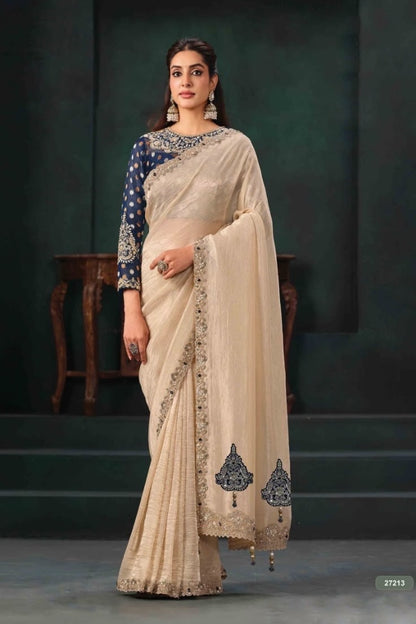 Cream ready-to-wear saree with navy embellished blouse, ornate border and decorative hem motifs