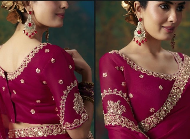 Magenta saree blouse with embroidered gold neckline, sleeve cuffs, and scattered embellishments