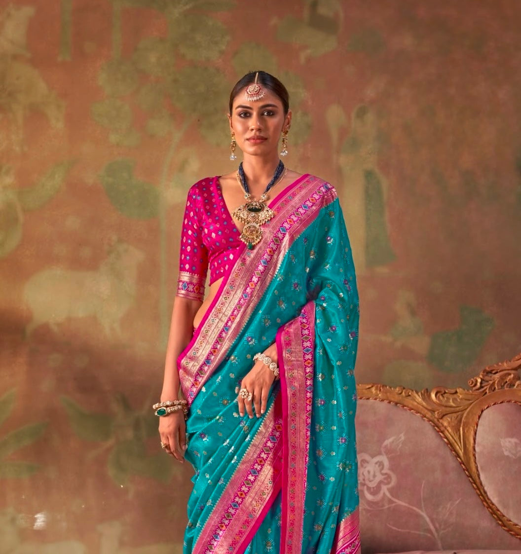 Teal and magenta patola silk easy saree with pink border, draped with short sleeves