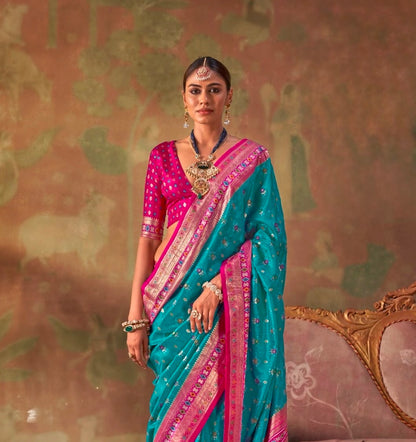 Teal and magenta patola silk easy saree with pink border, draped with short sleeves
