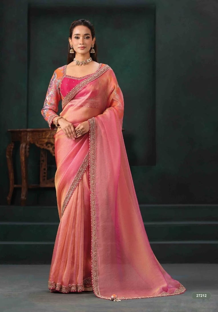 Peach-pink saree with ornate border, draped with a matching long-sleeve embellished blouse.