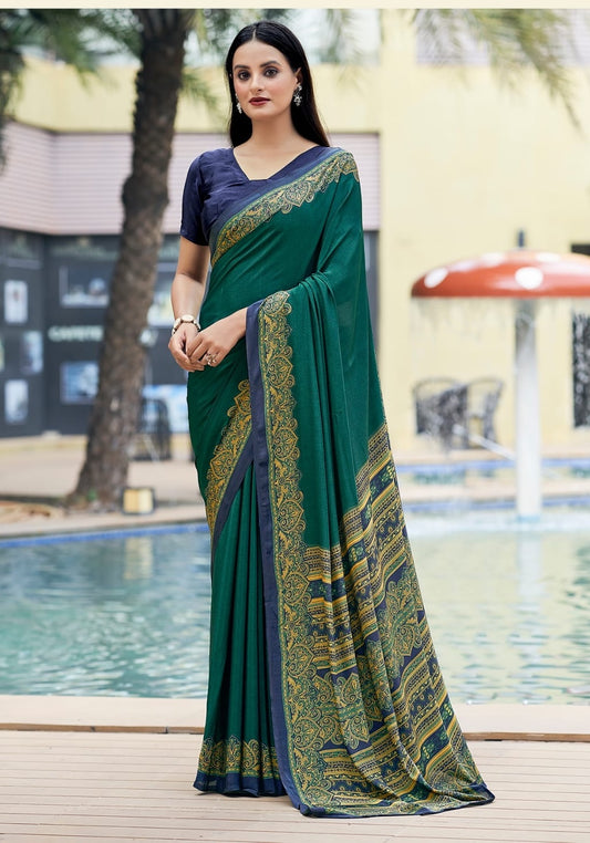 Teal green crepe silk saree with gold patterned border and draped pallu, full length