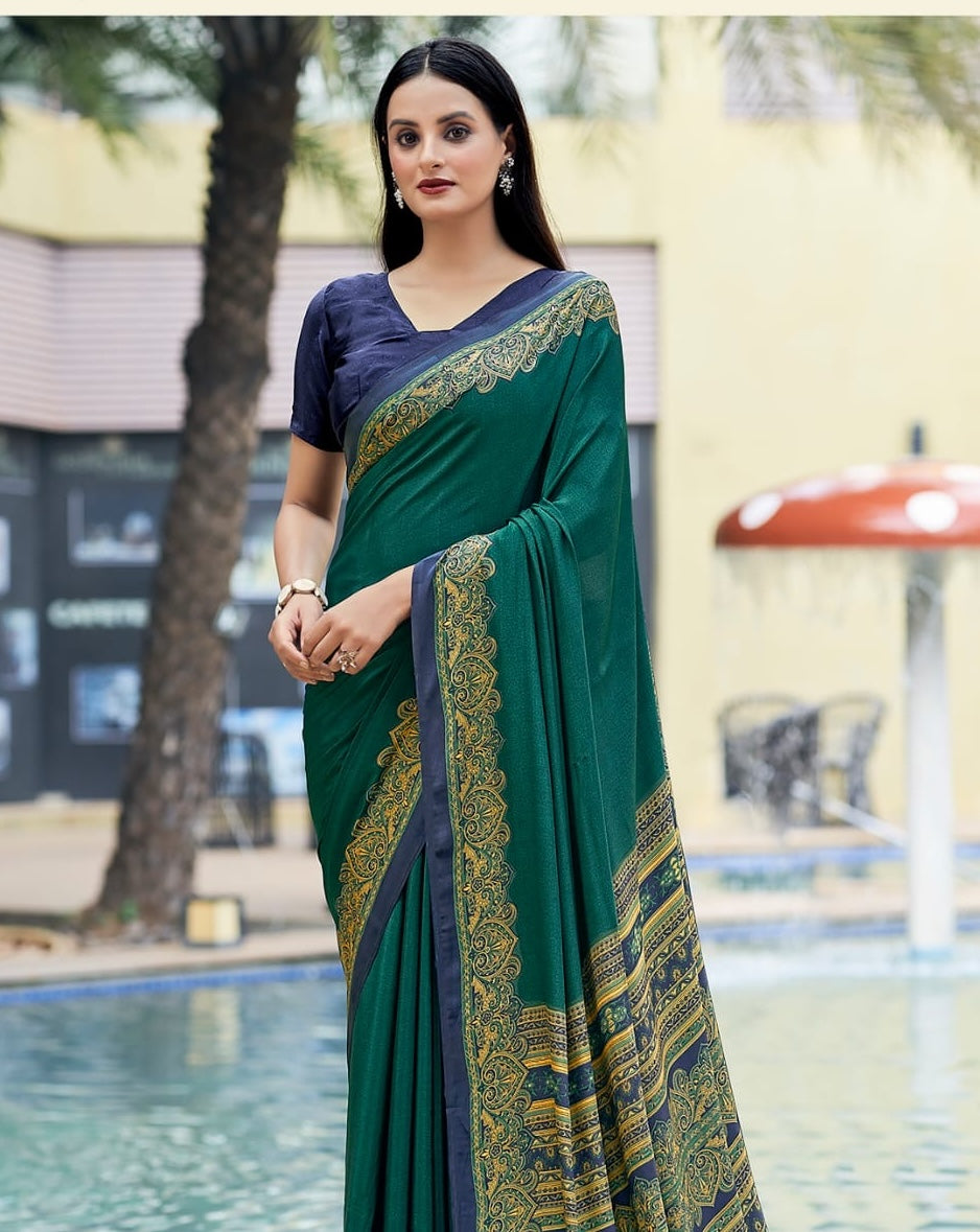 Teal green crepe silk saree with gold patterned border, shoulder drape detail