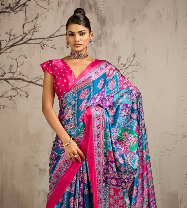 Close view of a model wearing a patterned silk saree with a magenta border and dotted blouse