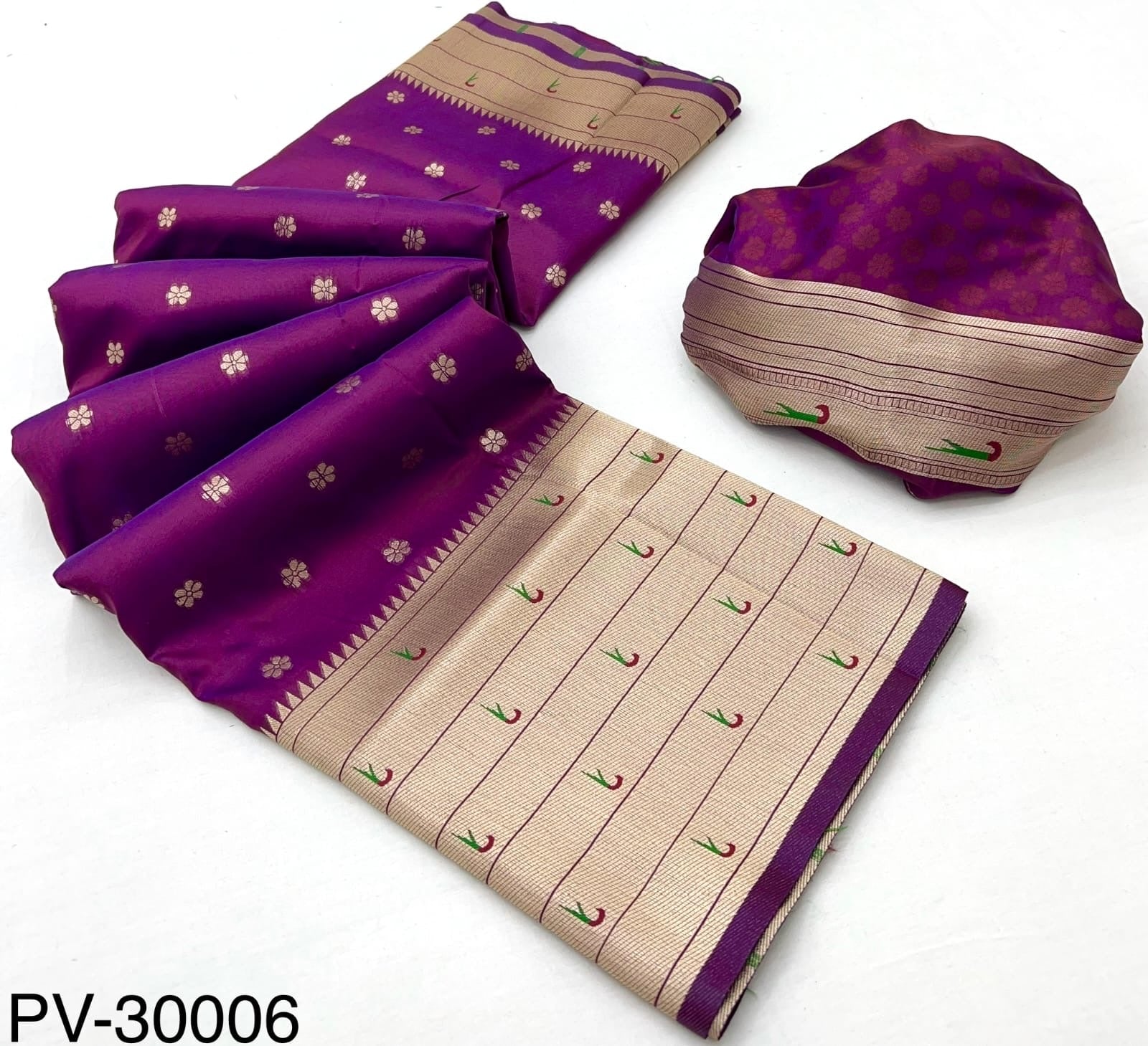 Folded magenta and beige silk saree set with patterned pallu and matching roll