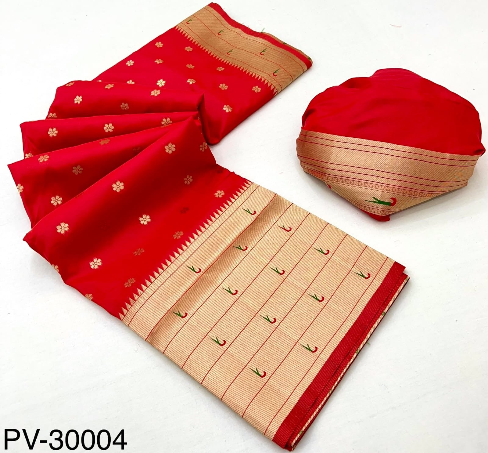 Folded red saree with beige patterned border and matching fabric pouch