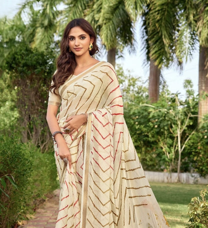 Off-white printed saree with chevron design, red piping on pallu, matching short-sleeve blouse