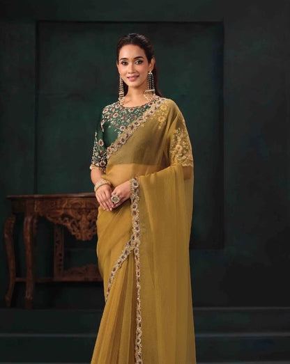 Mustard gold saree with floral blouse, embroidered sleeve and decorative edge